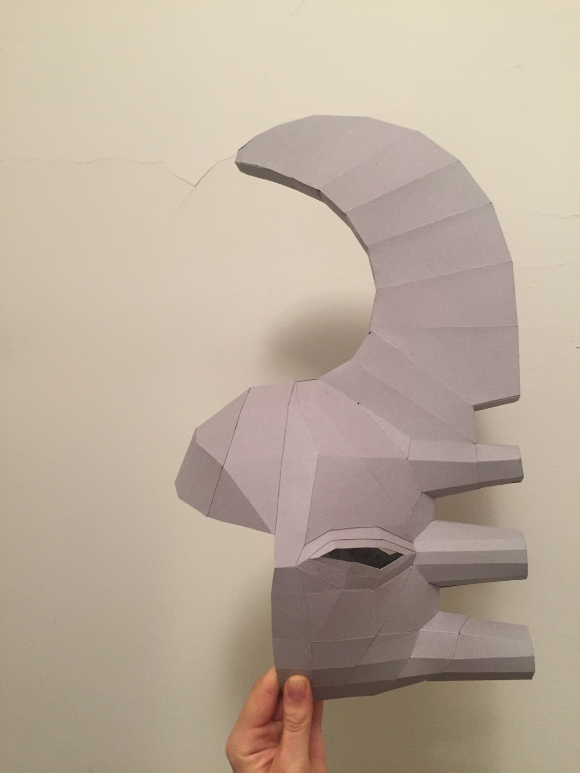 Grey geometric mask component study showing a curved crest and projecting forms