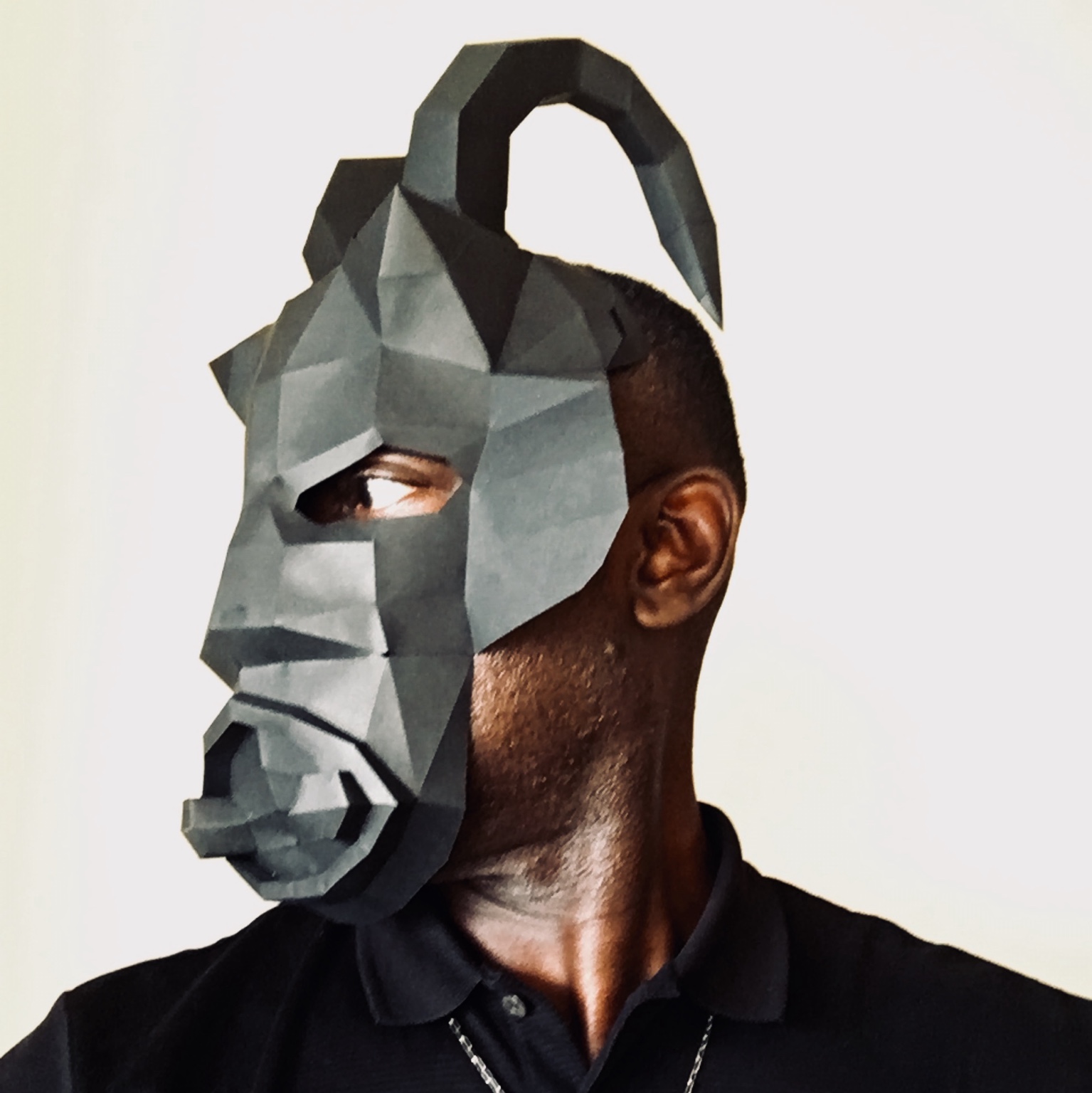 A contemporary geometric mask worn in profile