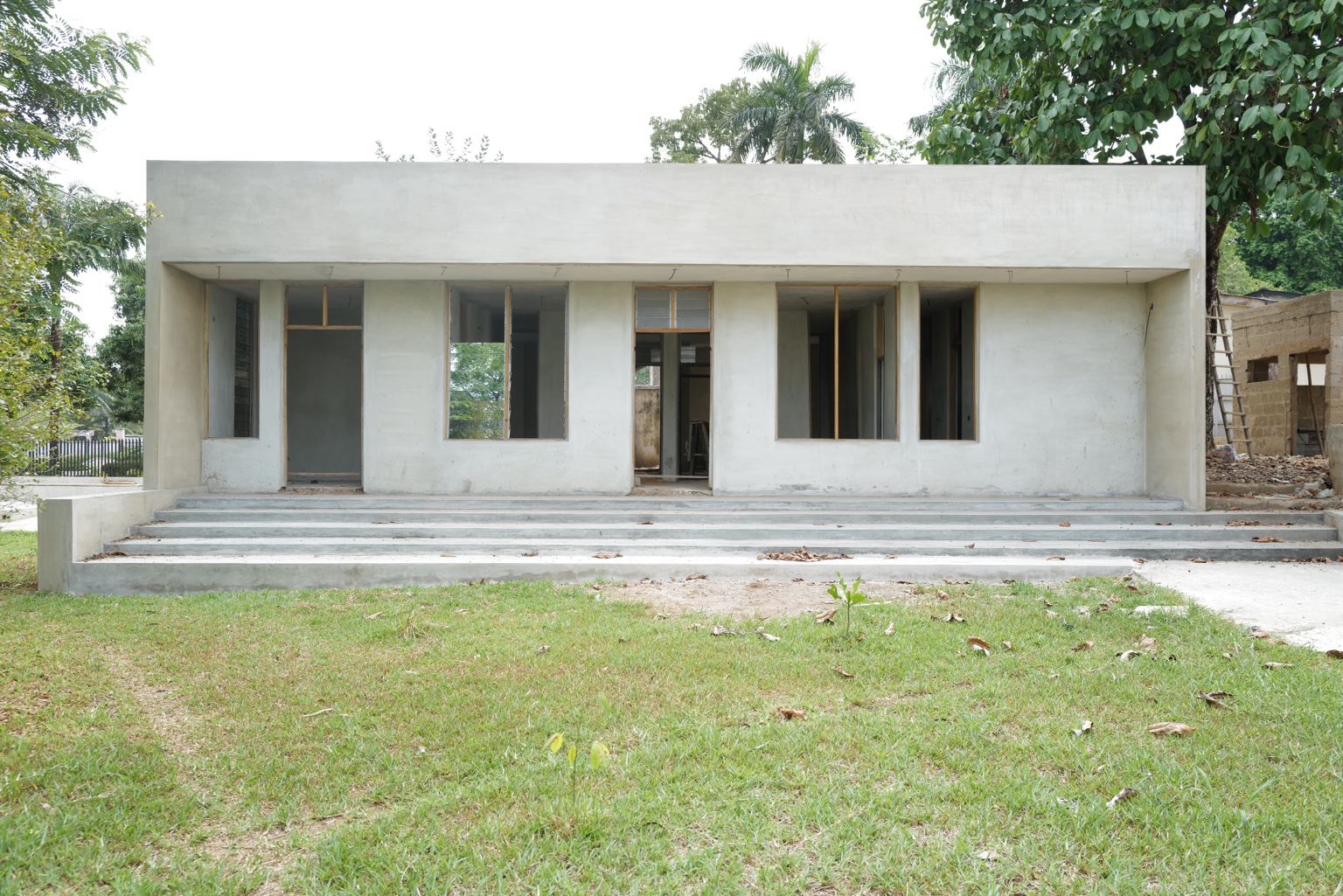Frontal view of the Okpara House facade while glazing was in progress