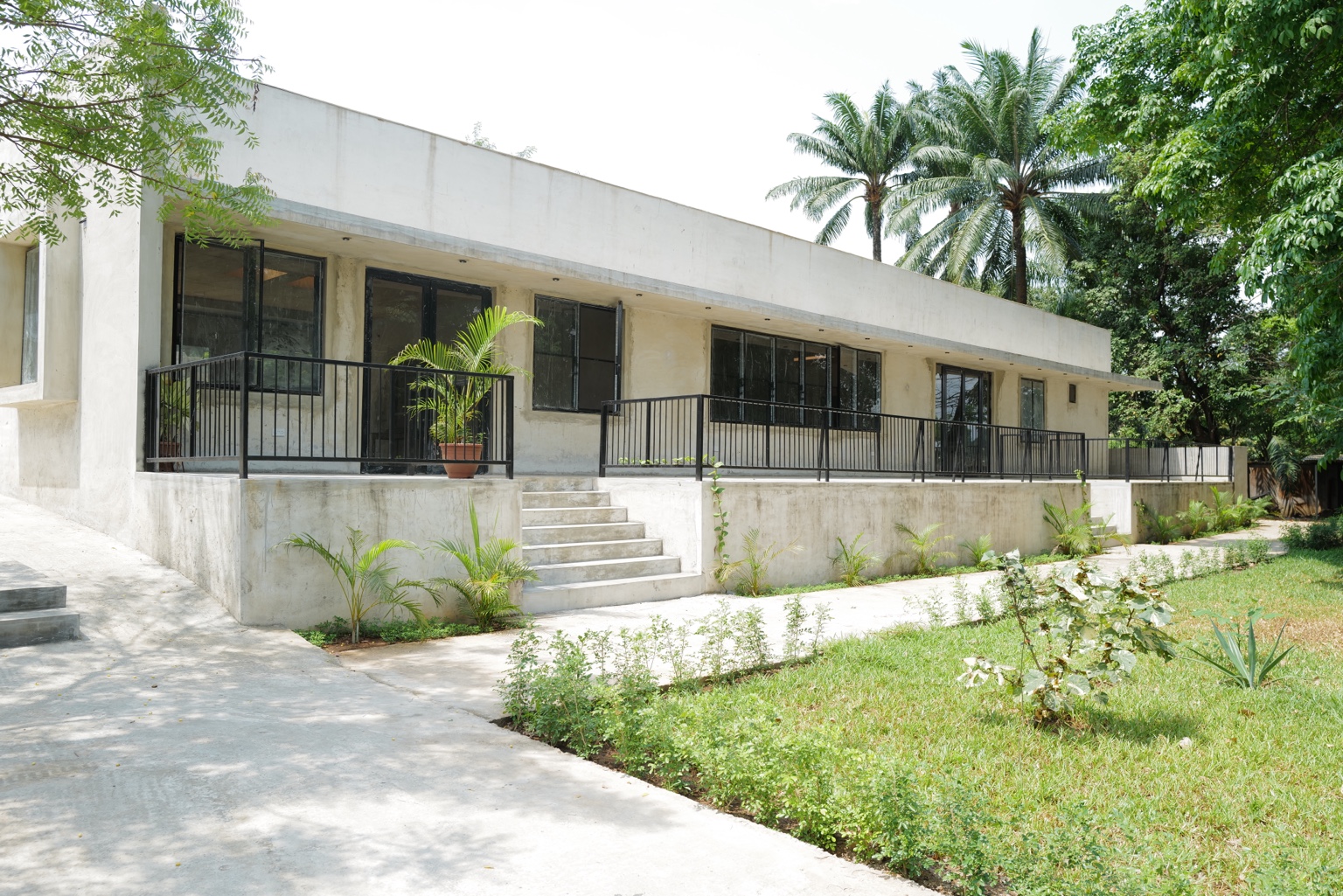 Okpara House set within its garden and palm trees in Oraifite
