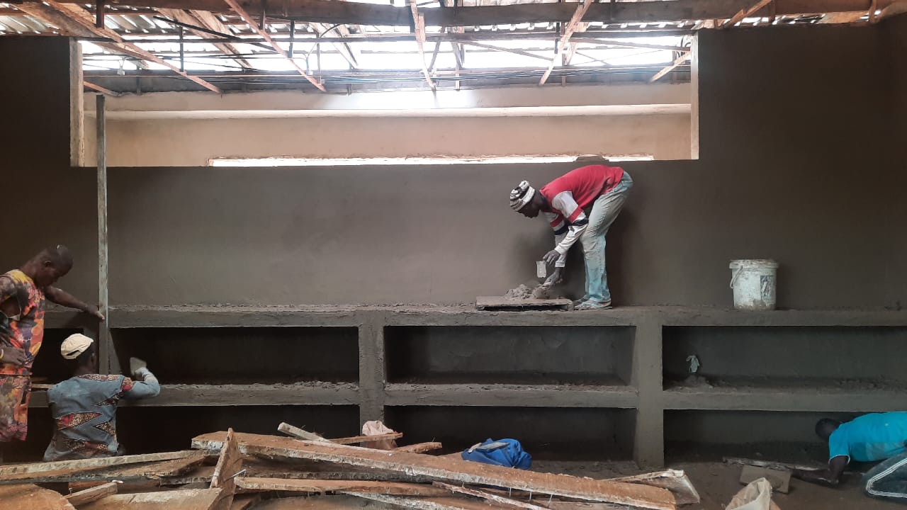 Craftspeople shaping the built-in interior shelving at Okpara House
